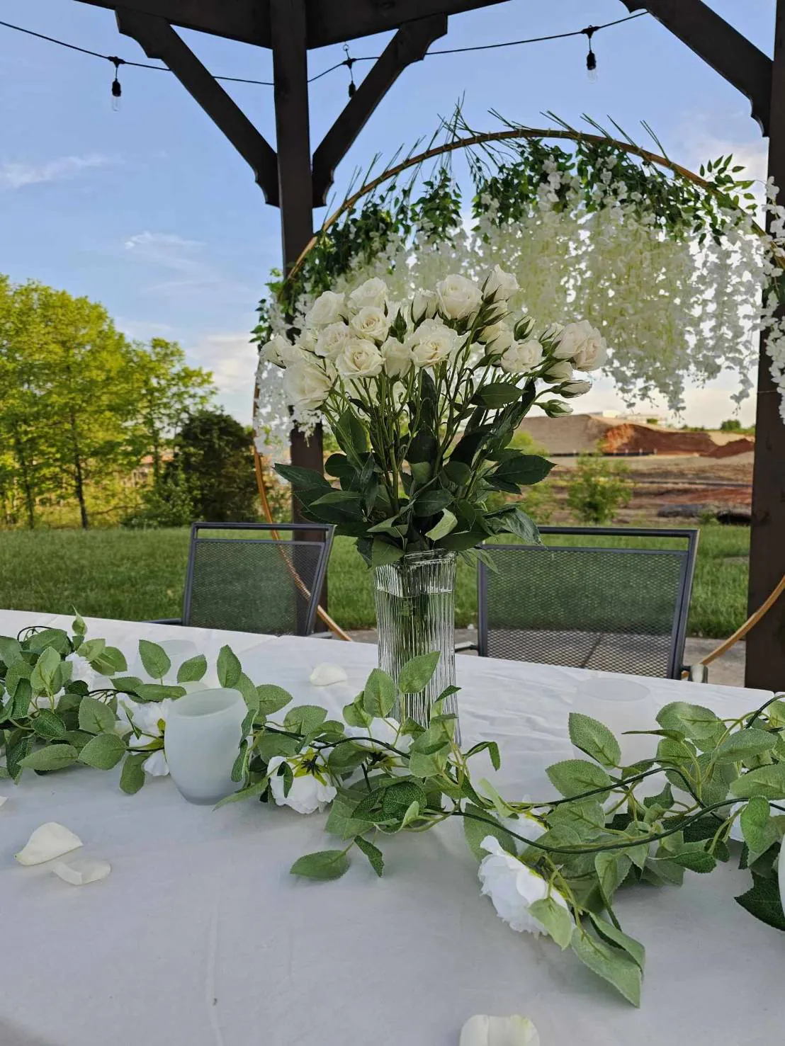 White flower centerpiece on a patio table set for an event
