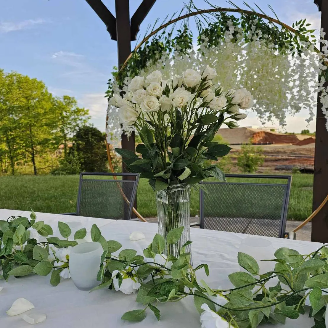 White flower centerpiece on a patio table set for an event