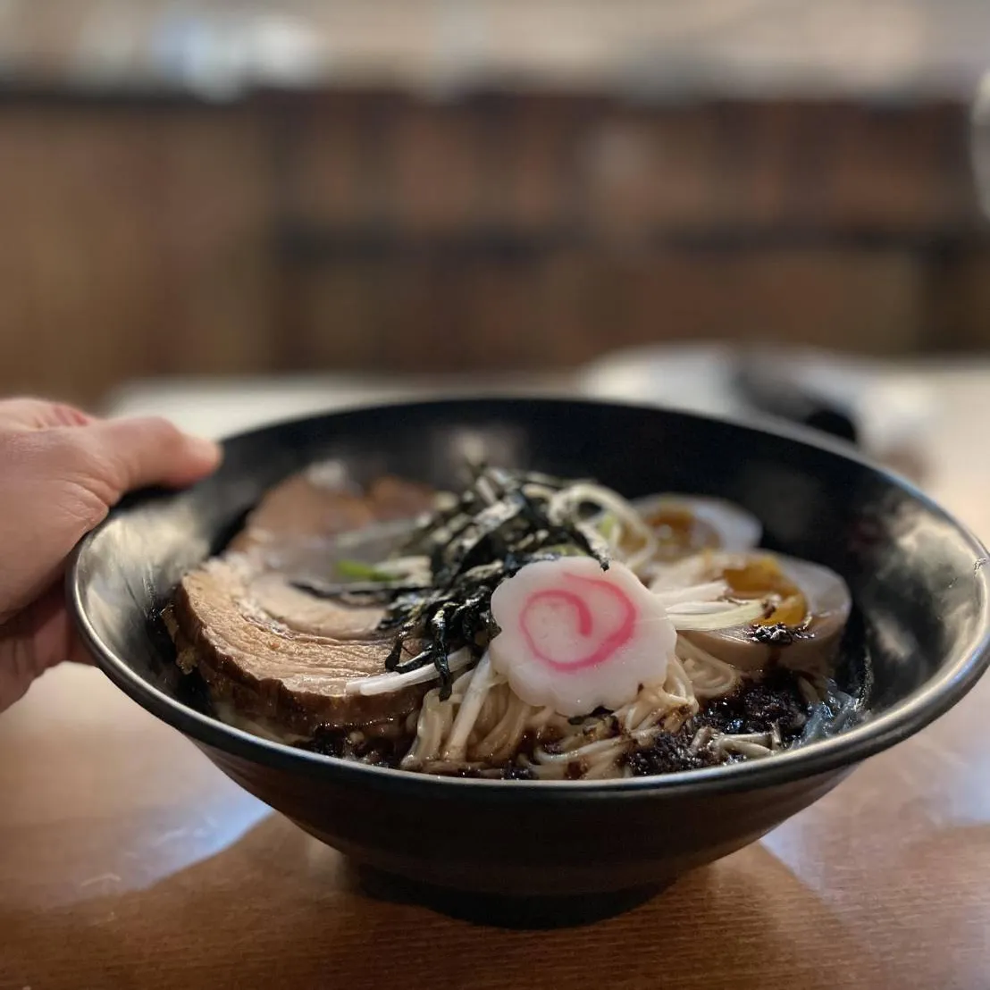 Bowl of ramen with chashu pork, soft-boiled egg, nori and fish cake
