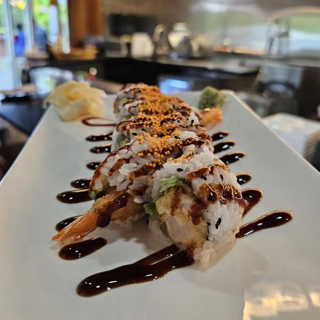 Shrimp tempura sushi roll topped with crunch and eel sauce